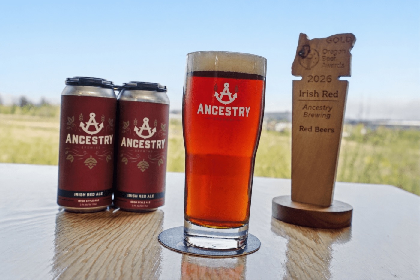 Irish Red Ale cans, a pint and the award trophy